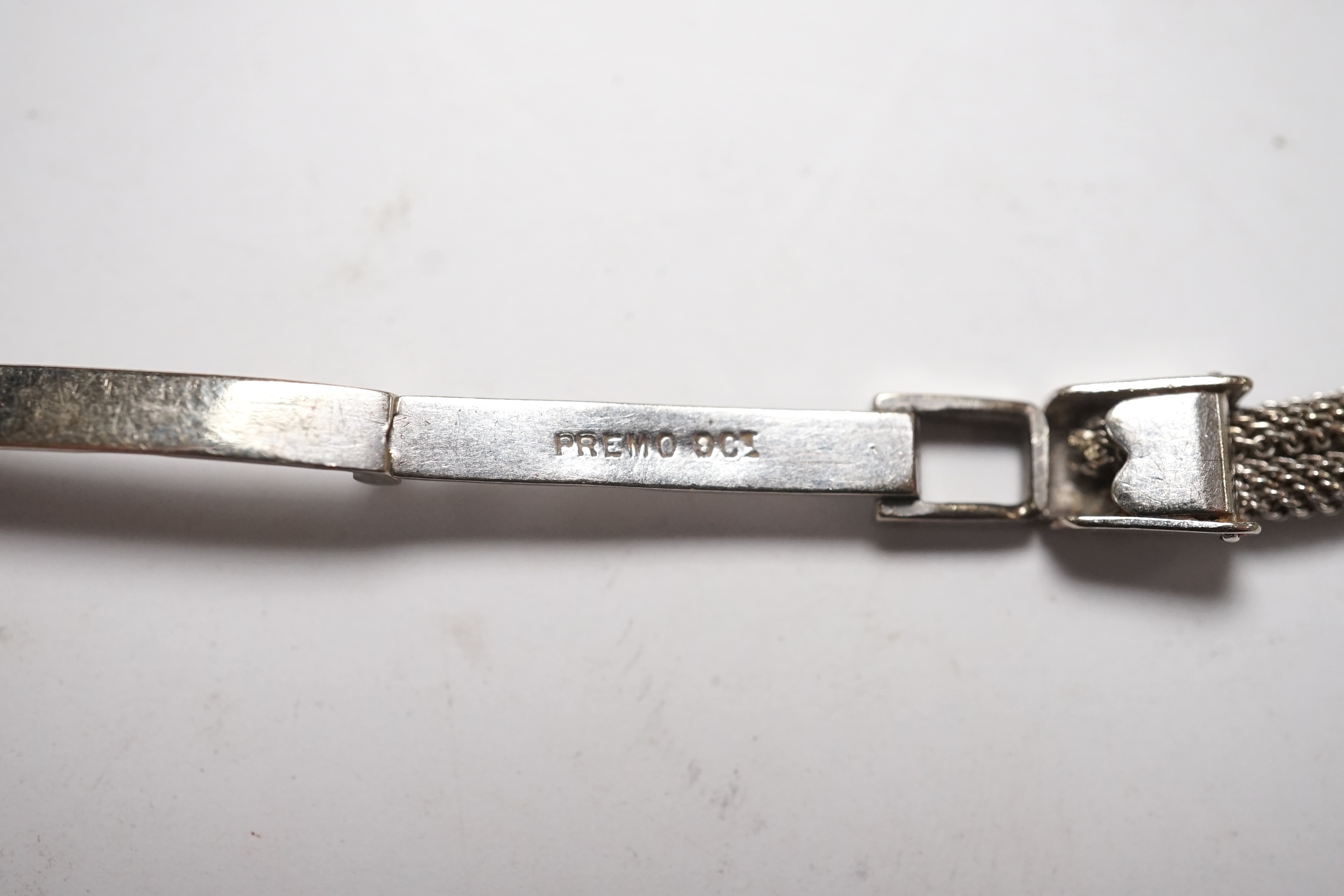 A lady's mid 20th century white metal (stamped platinum) and diamond set manual wind cocktail watch, on a 9ct white metal twin strand bracelet, overall length 16.5cm, gross weight 17.6 grams/ Condition - fair to good